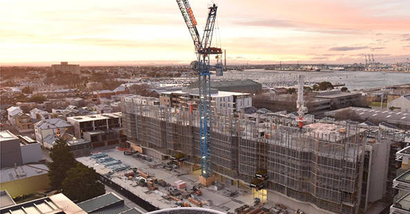Photo of the Merchant apartment construction site at sunset July 2023