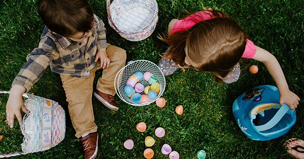 Young kids sitting on grass with easter eggs and baskets in Rosella Rise community by AVJennings located in Warnervale, NSW 2259. Land for sale Warnervale, house and land packages Warnervale. 